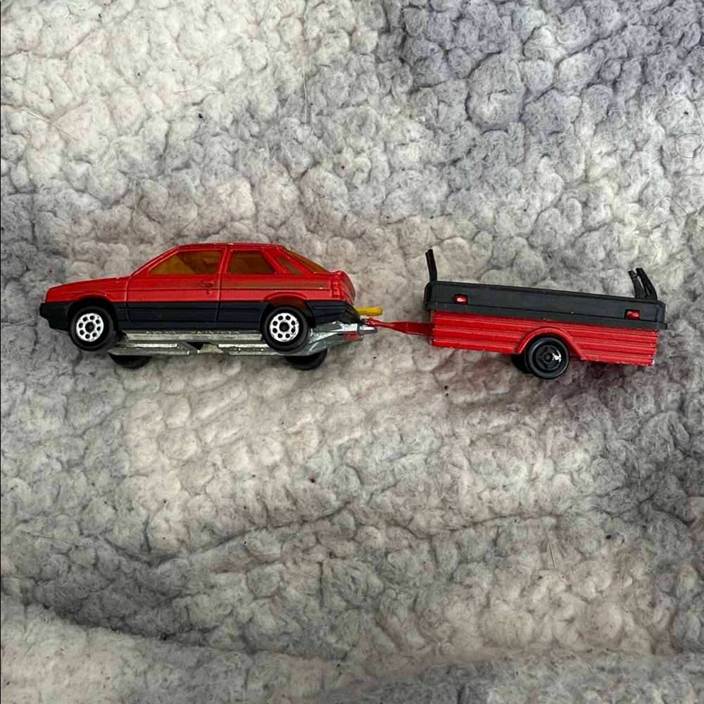 Red and Black Toy Car with Trailer